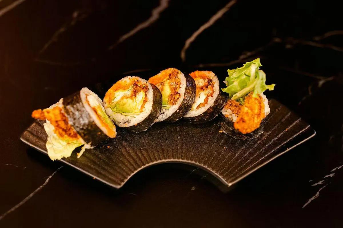 Crispy soft shell crab with lettuce, avocado, and masago wrapped in seaweed and sushi rice at Oishii Express, a Japanese Restaurant in Oklahoma City